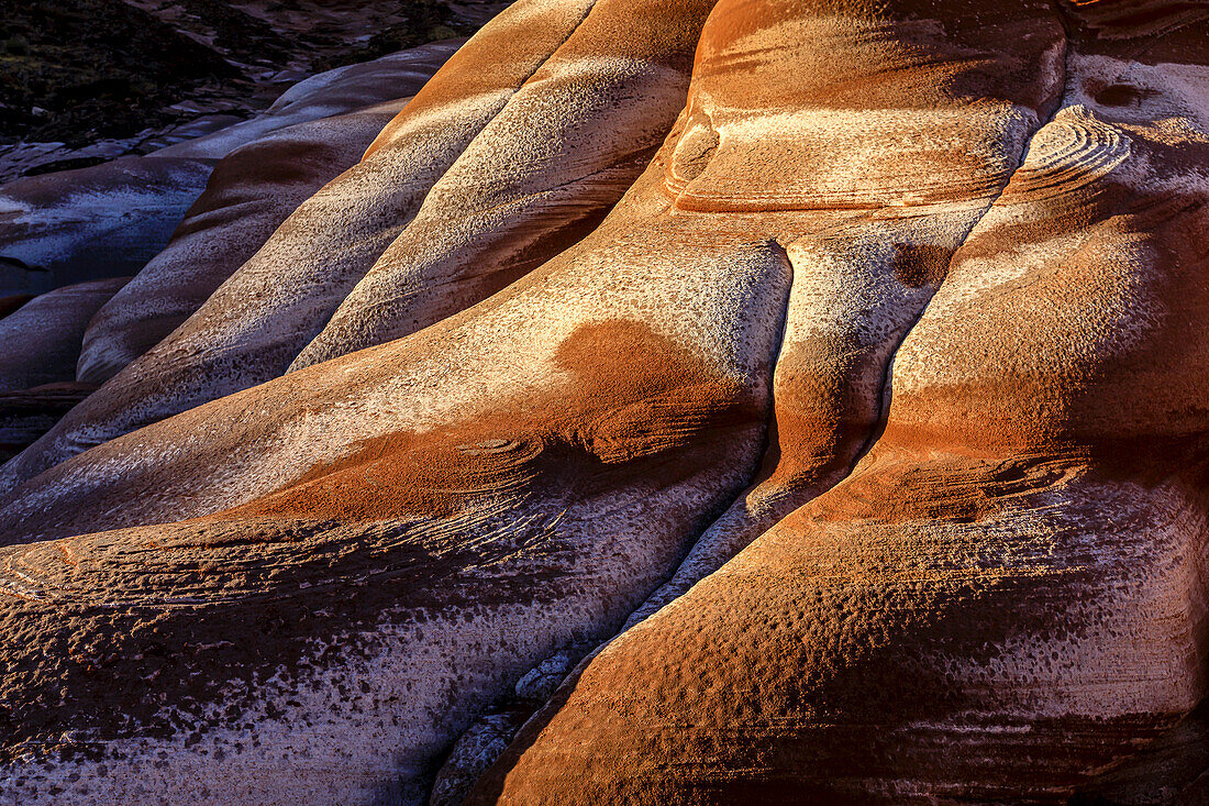 Abstract patterns of salt stains on red sandstone formations, on the Baja Peninsula at Puerto Gato.