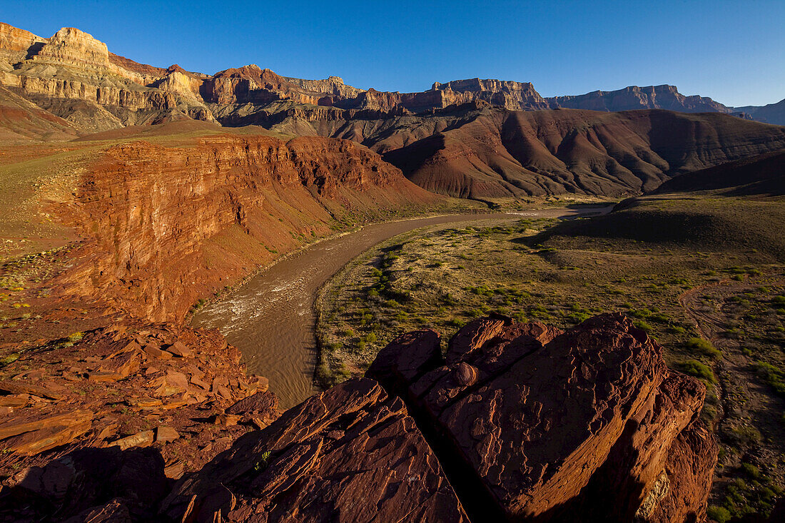 View of the Colorado River from a canyon ledge.