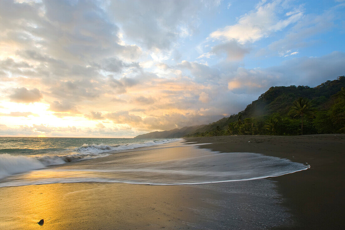 The tide rises at sunset on a remote beach in Costa Rica