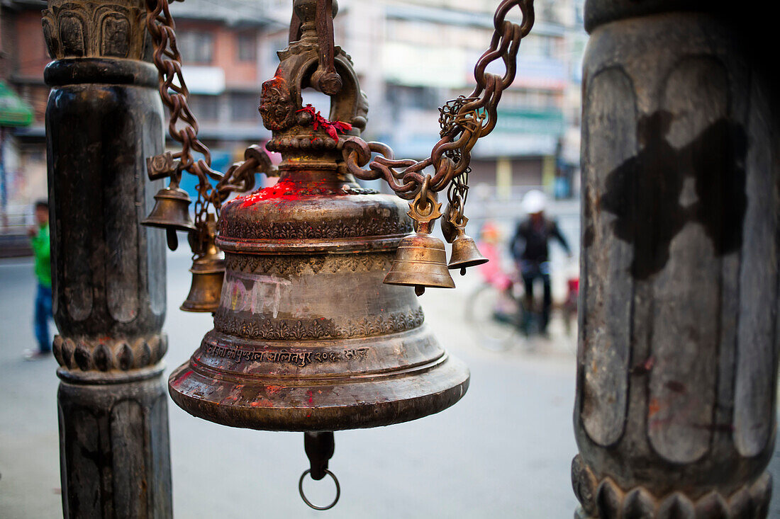 A bell adorns a Hindu shrine.