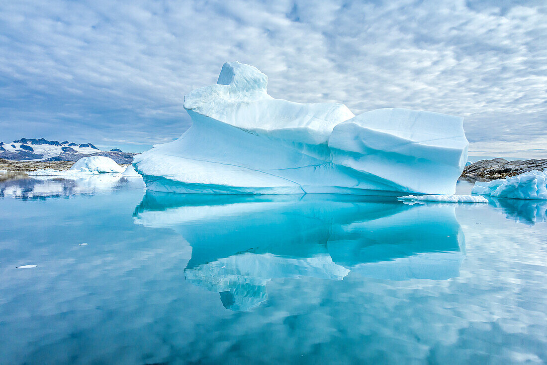 Sculpted icebergs and reflections in Semerlik Fjord.