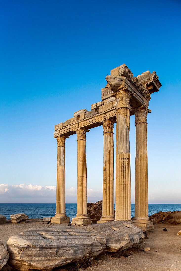 Roman and Hellenistic ruins of the Temple of Apollo under a bright blue sky, a ruined Roman entrance, at Side, near Manavgat, on the Mediterranean coast of Anatolia; Side, Anatolia, Turkey