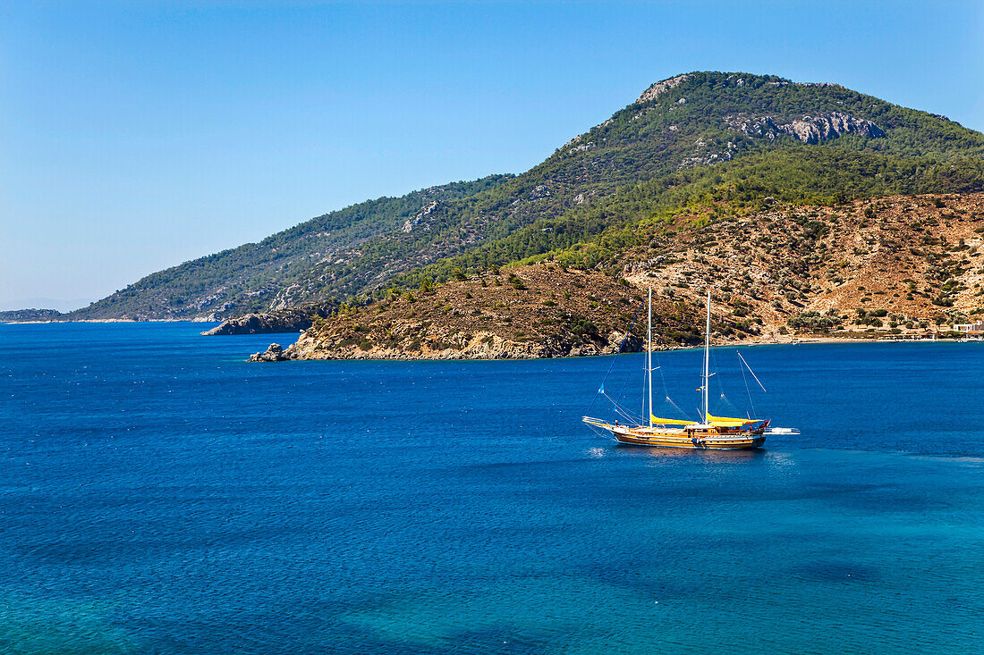 A gulet moored in a bay just west of Datca, Turkey.; The coast of the Datca peninsula, near Marmaris, western Anatolia, Turkey.