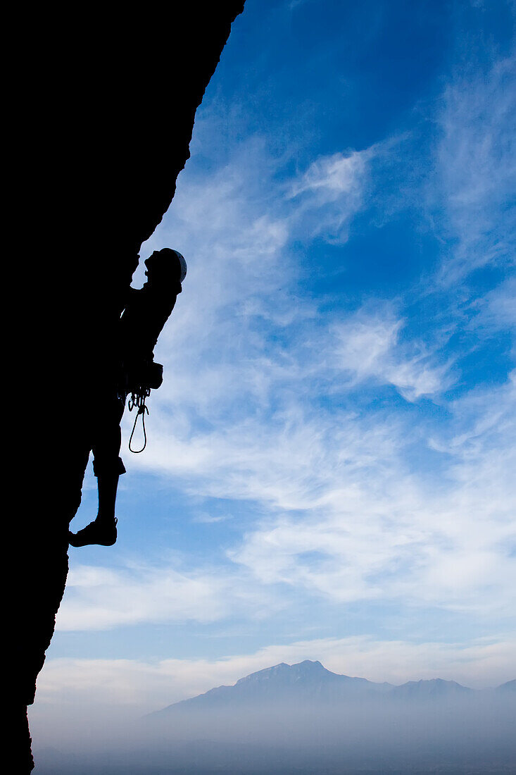 A climber ascends an overhang 500 feet off the ground.