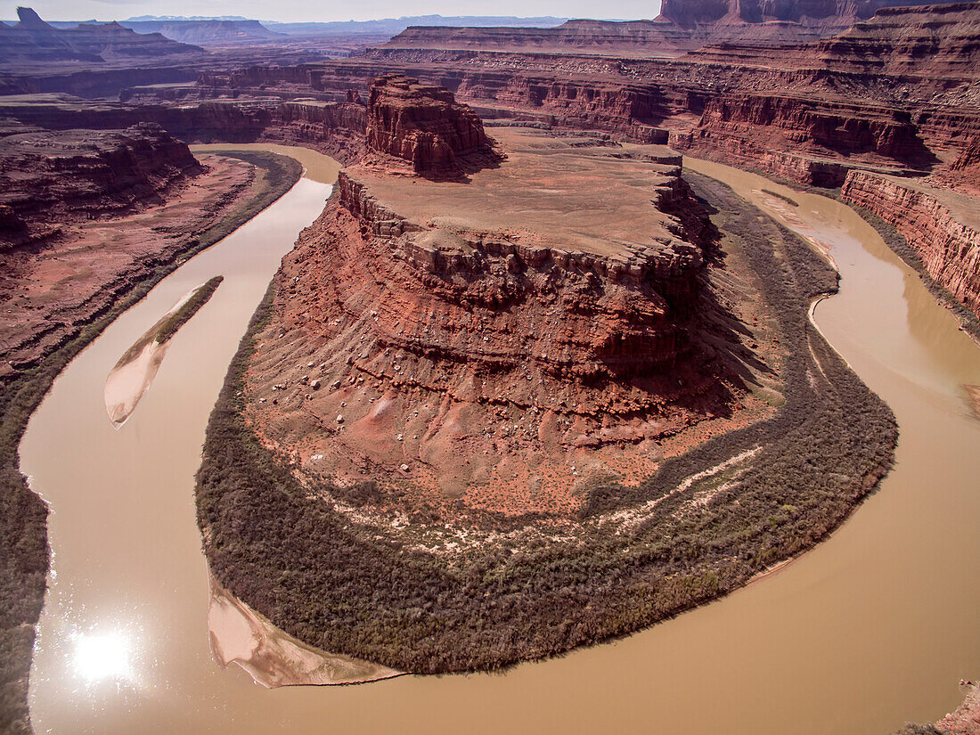 The Colorado River meanders around rock formations at Horseshoe Bend.