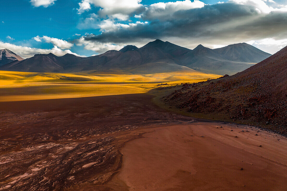 A high altitude valley surrounded by volcanos in the Atacama Desert.
