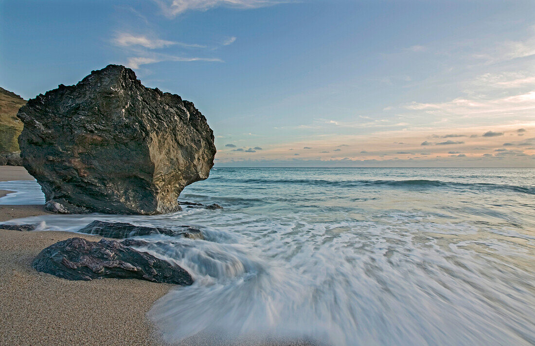A seashore boulder at dusk.; Mattiscombe Beach, Start Point, near Kingsbridge, Devon, Great Britain.