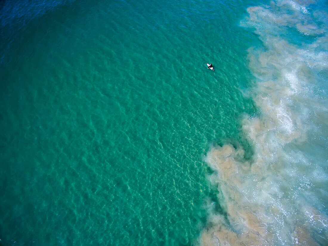 Aerial view of a surfer off Zuma Beach.