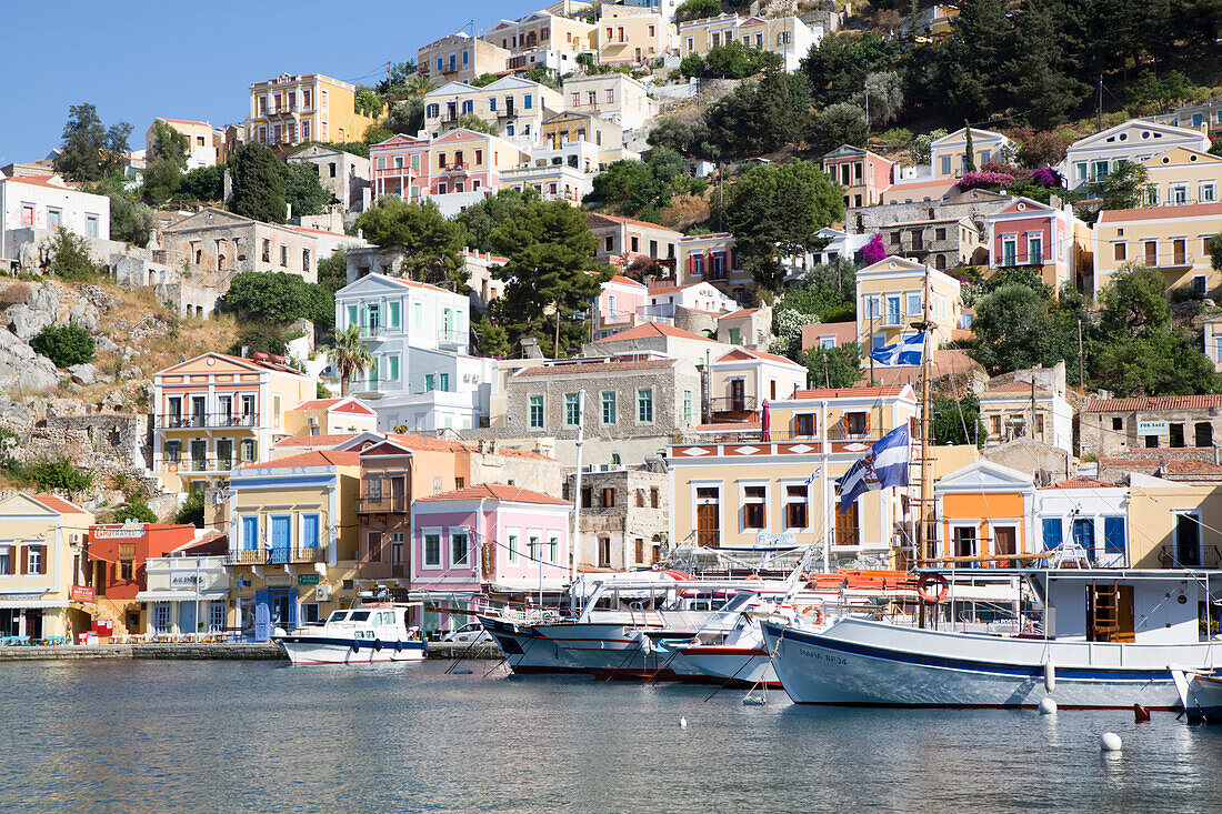Cabin Cruisers moored along the shore at Gialos Harbor, Symi (Simi) Island; Dodecanese Island Group, Greece