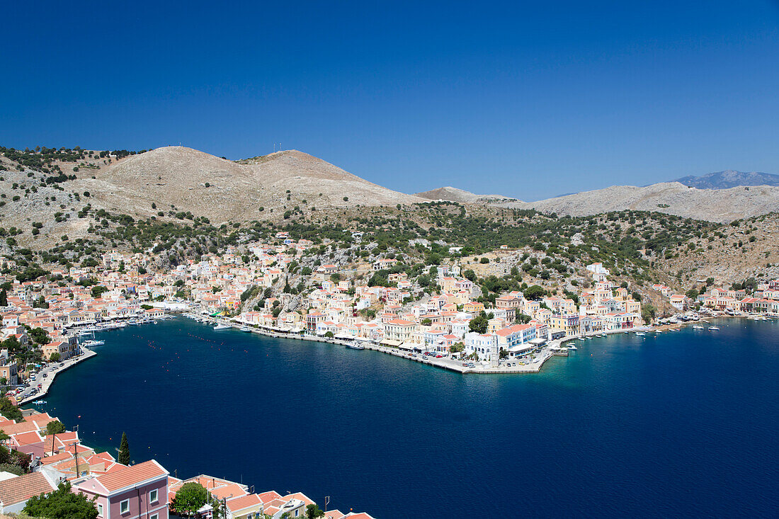 Aerial overview of the Gialos Harbor waterfront and town of Symi (Simi) Island; Dodecanese Island Group, Greece