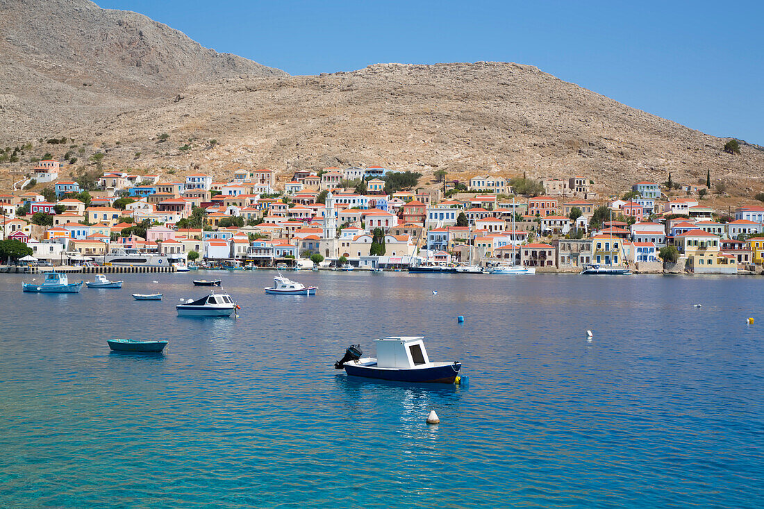 Fishing boats anchored off shore in the harbor at Emborio, the main town on Halki (Chalki) Island; Dodecanese Island Group, Greece