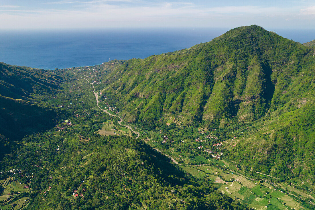 Overview of Mount Abang, with a blue, cloudy sky and lush vegetation; Abang, Kabupaten Karangasem, Bangli Regency, Bali, Indonesia