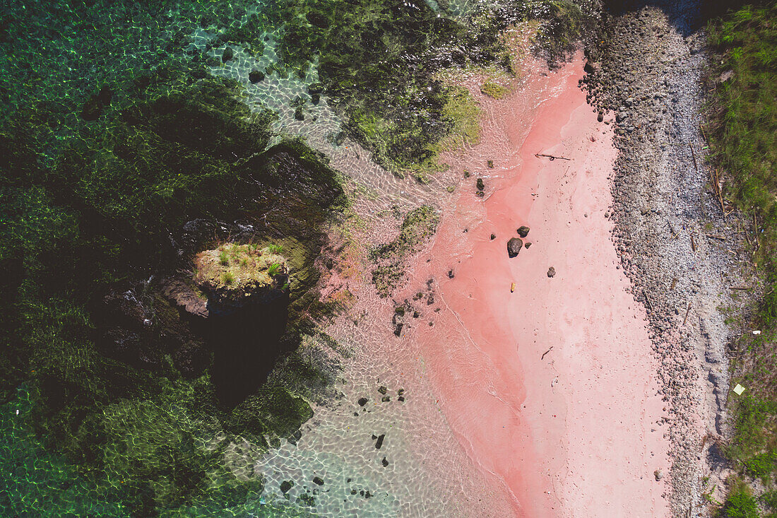 View taken directly above of a pink sand beach along the shore of Padar Island in Komodo National Park; East Nusa Tenggara, Lesser Sunda Islands, Indonesia