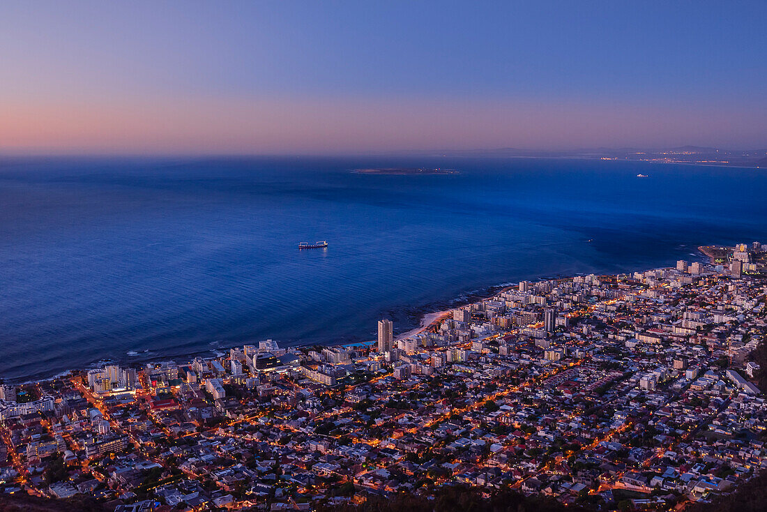Overview of Cape Town city skyline and shoreline along the Atlantic Ocean coast at dusk; Cape Town, Western Cape Province, South Africa