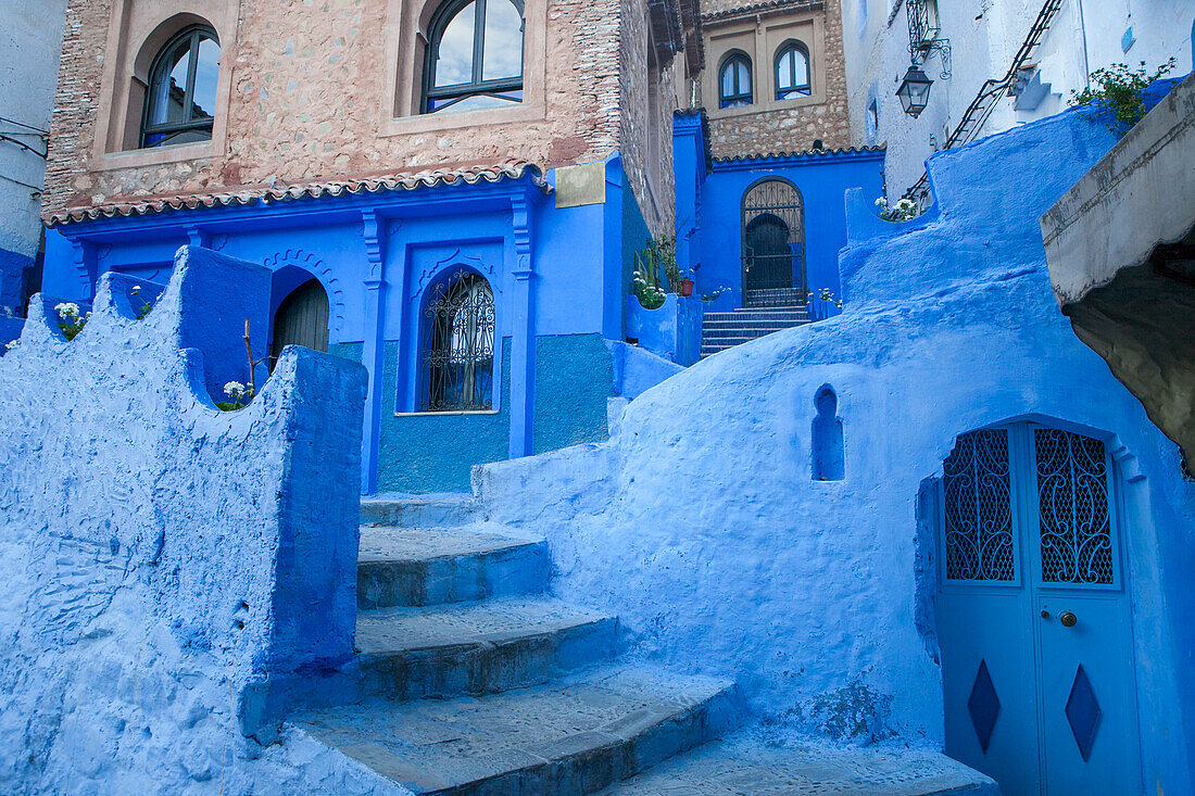 A view into the winding and steep streets of Chefchaouen - the blue city of Morocco; Chefchaouen, Morocco