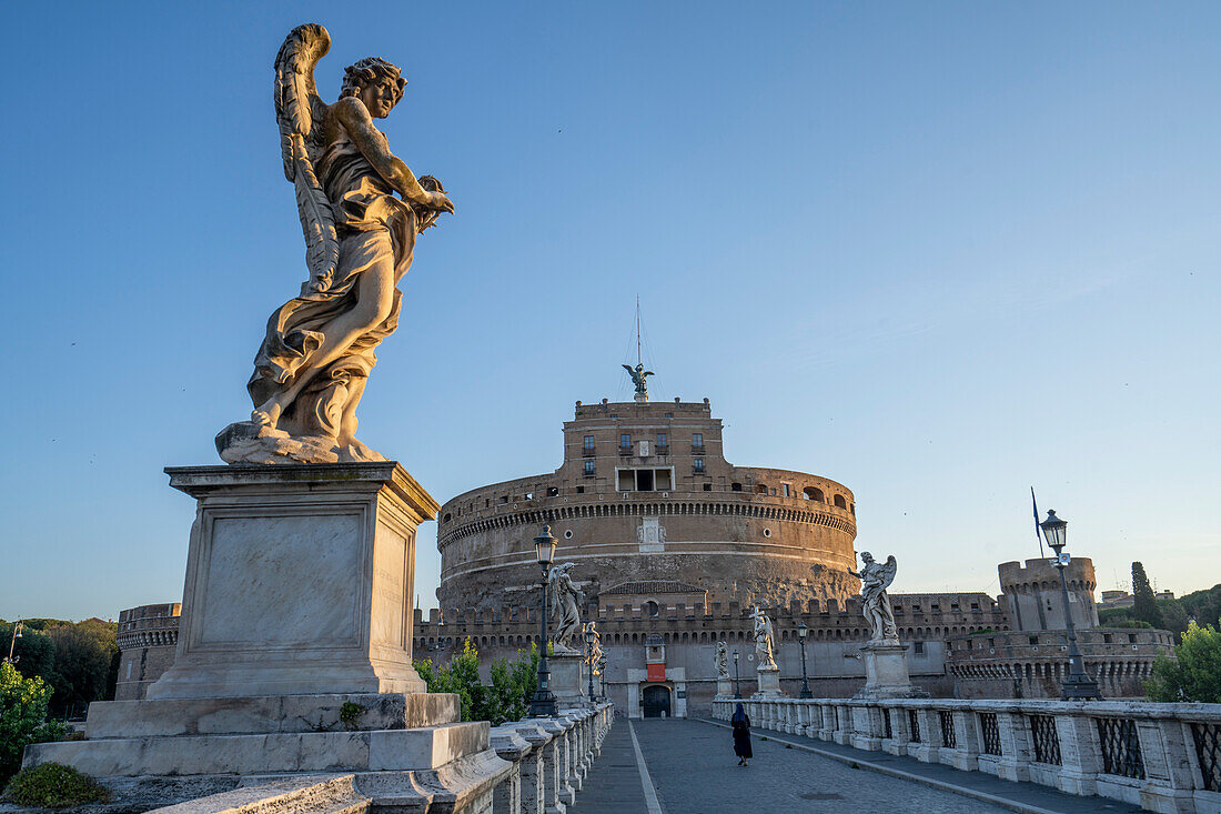View of the Castel Sant'Angelo (Mausoleum of Hadrian) with a Nun crossing the Ponte Sant'Angelo; Rome, Lazio, Italy