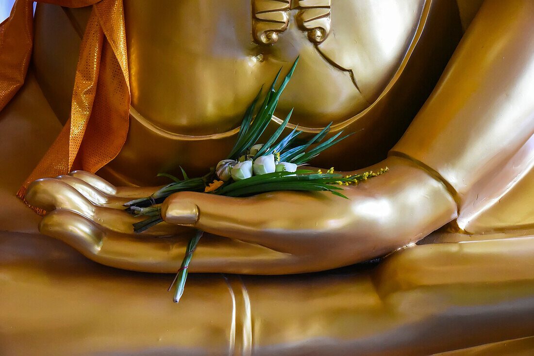 Detail of flowers in the hand of Buddha statue; Thailand
