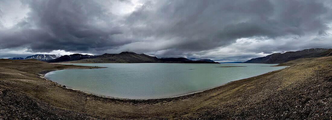 Panoramic view of 8 24mm high portrait images, looking across at the teams base camp on the banks of lake Centrum S??. The larger triangular tent known by the team as the 'wigwam' (Wigwam camp) was used as a general cummunal space where the team sat and ate meals discussing plans etc etc...; Northeast Greenland , Greenland