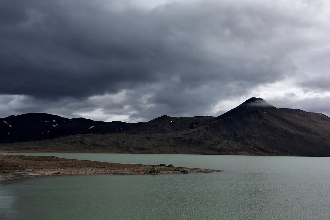 View looking across at the teams base camp on the banks of lake Centrum S??. The larger triangular tent known by the team as the 'wigwam' (Wigwam camp) was used as a general cummunal space where the team sat and ate meals discussing plans etc etc...; Northeast Greenland , Greenland