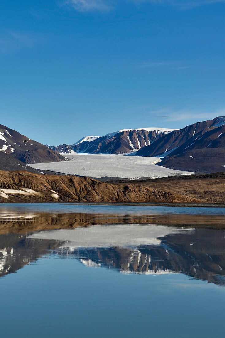 On the day of departure from the eastern side of lake Centrum S??, the five of us took a boat ride down the outlet river towards the nearest glacier and then the coast (not reaching the coast). The water surface was like glass creating the most magnificent refelctions as 100% perfect as the mountains were above the surface. These three photographs show the nose of the nearest glacier we encounted. We'd had it in our view when walking for so many days in Vandredalen, but now we were up close and personal with it. Amazing.; Northeast Greenland , Greenland