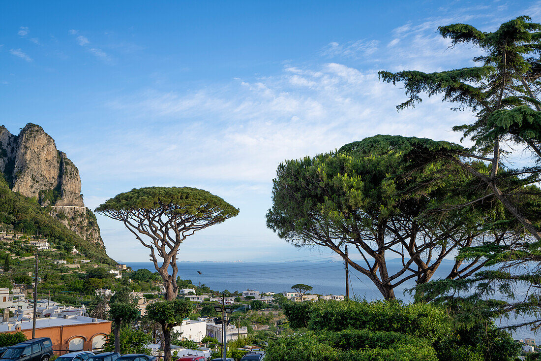 Blick über die Küste des Tyrrhenischen Meeres und Capri-Stadt auf einem sattelförmigen Plateau hoch über dem Meer mit dem Hafen der Insel, Marina Grande, darunter; Neapel, Capri, Italien