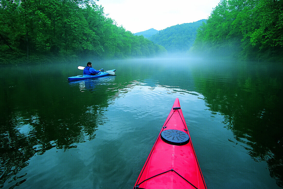 Rising mist on the river, reflections and kayaks.; Youghiogheny River, Pennsylvania.