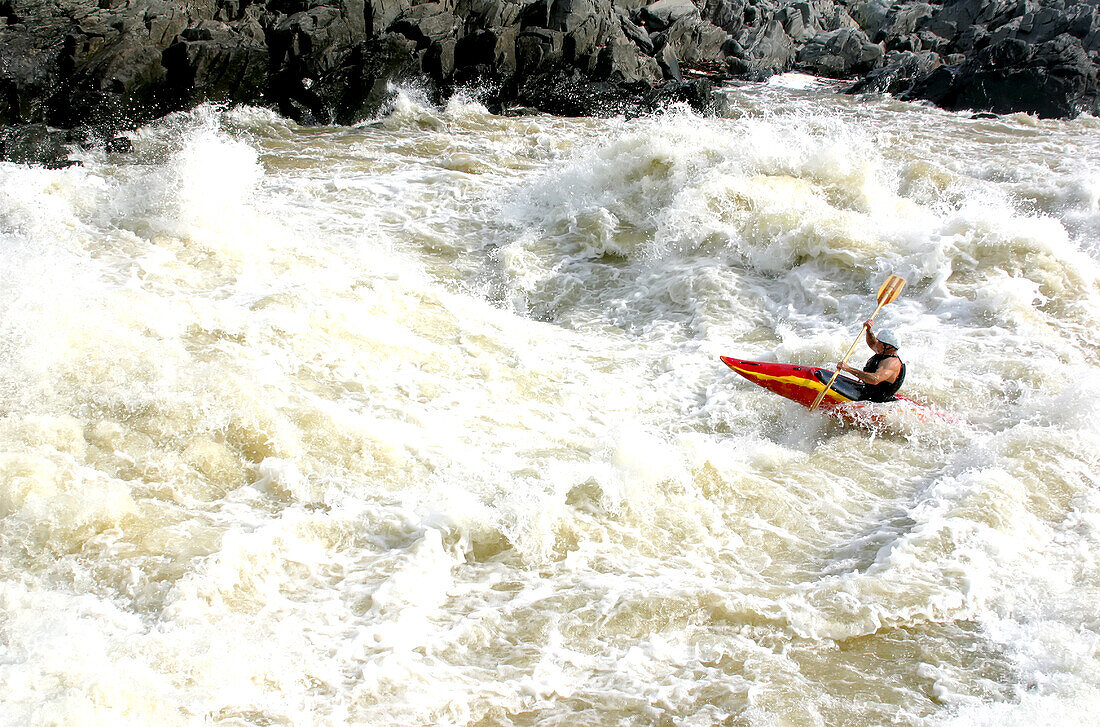 Whitewater kayaker in big rapids on the Potomac River.; Potomac River, Maryland.