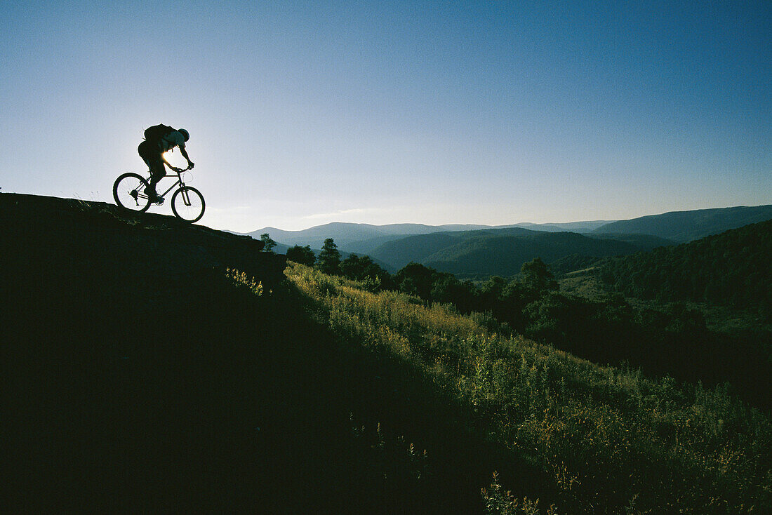 A mountain biker heads down a hill in Pocahontas County.; Pocahontas County, West Virginia.