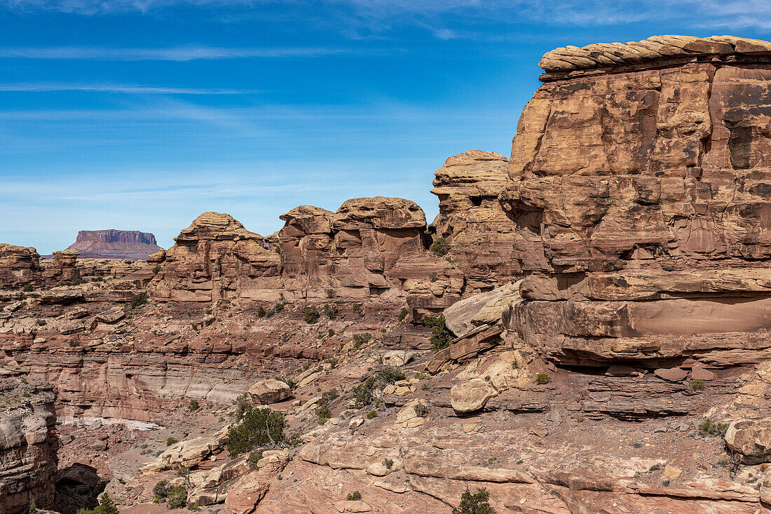 Stacked rocks and great geology at Big Spring Canyon in the Canyonlands National Park with Islands in the Sky in the background; Blanding, Utah, United States of America