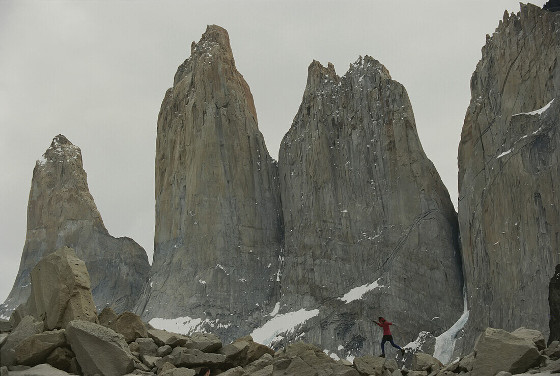 Woman jumping on rocks in Torres del Paine National Park.; TORRES DEL PAINE NATIONAL PARK, CHILE.