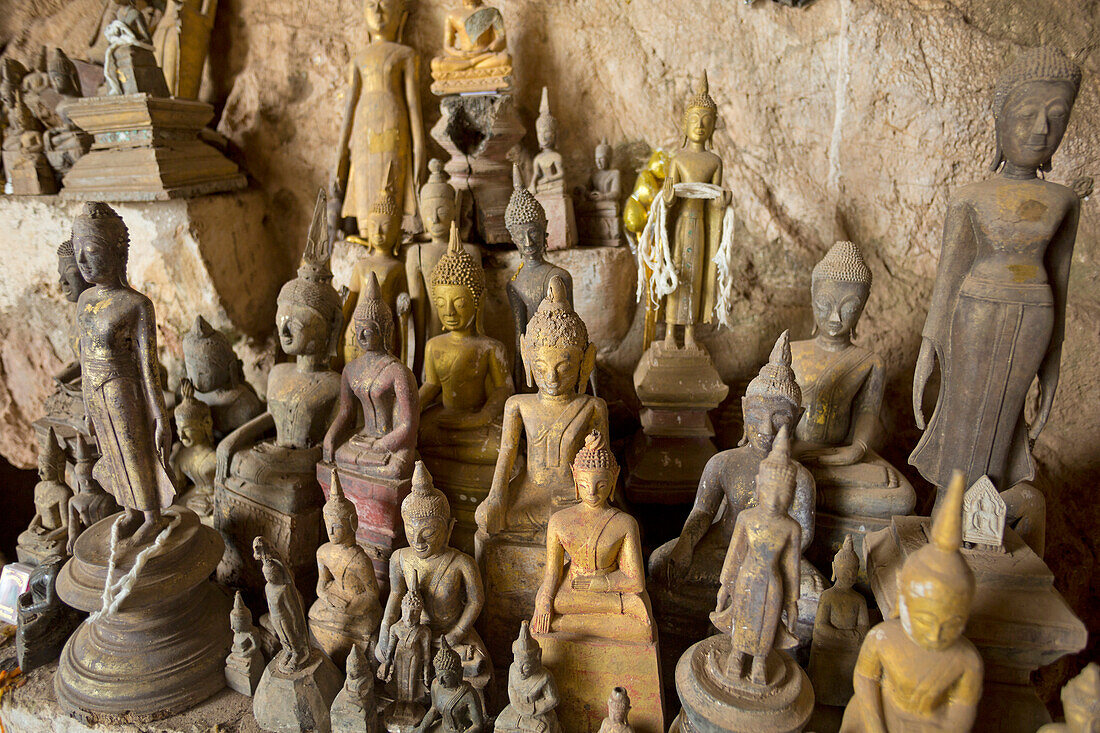 Buddha statues in Pak Ou Caves on the west side of the Mekong River in the Luang Prabang Province; Near Luang Prabang, Luang Prabang Province, Laos