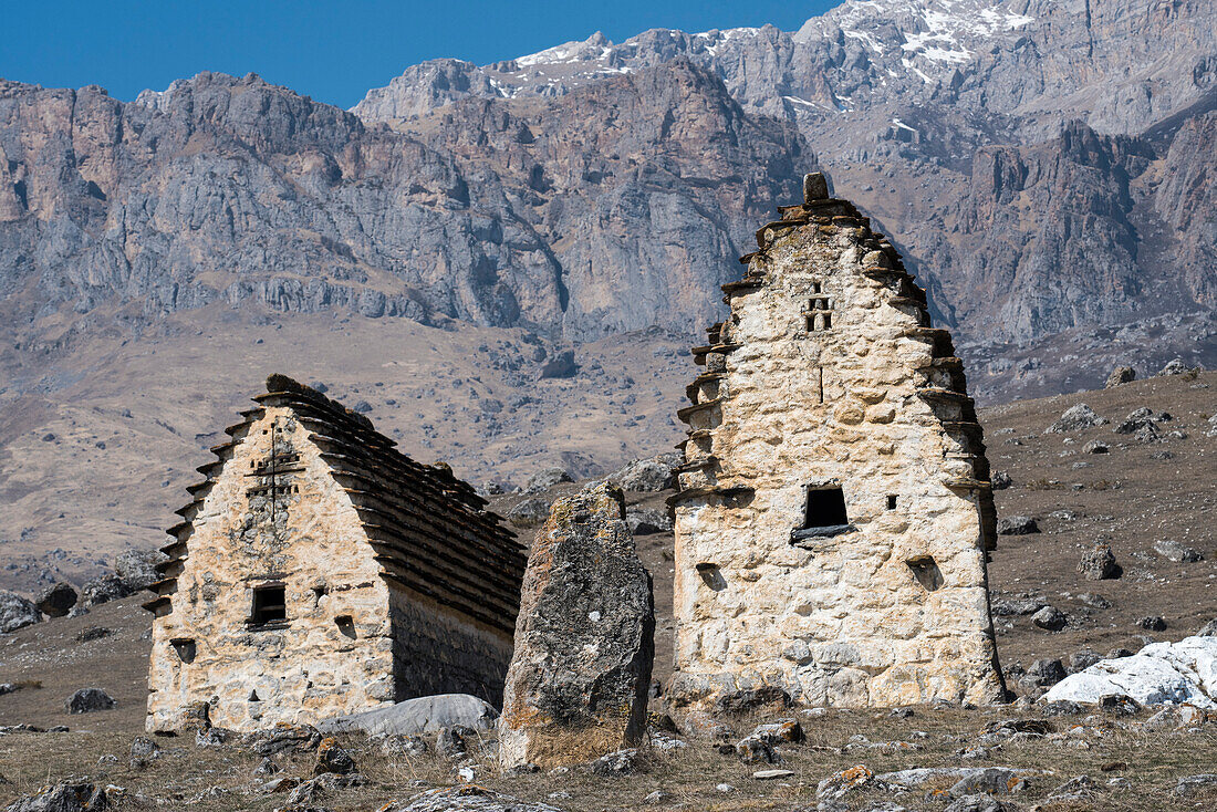 Gothic arch shaped roofs on the towers of silence on the mountainside in Ingushetia; Republic of Ingushetia, Russia