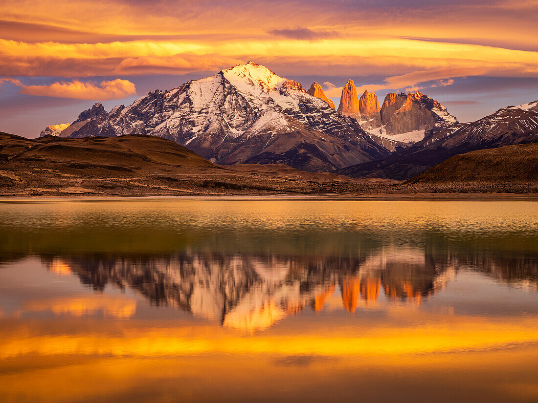 Lenticular clouds and reflection at sunrise in Lago Azul, Torres del Paine National Park; Patagonia, Chile