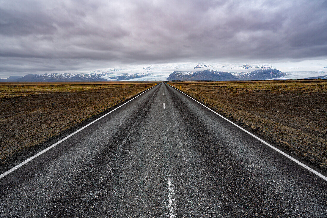 Looking down the south coast highway in Iceland into a scene of beauty with glaciers and mountains; South Iceland, Iceland