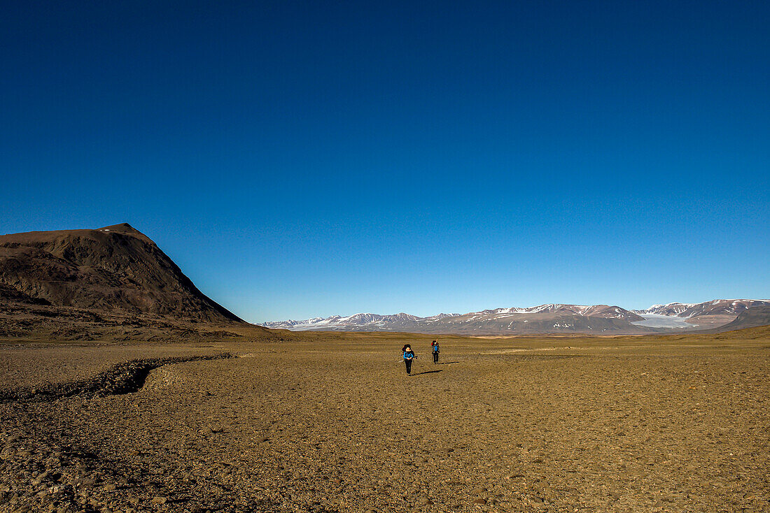 Team members on a climate change expedition explore a vast valley in Northeast Greenland; Greenland
