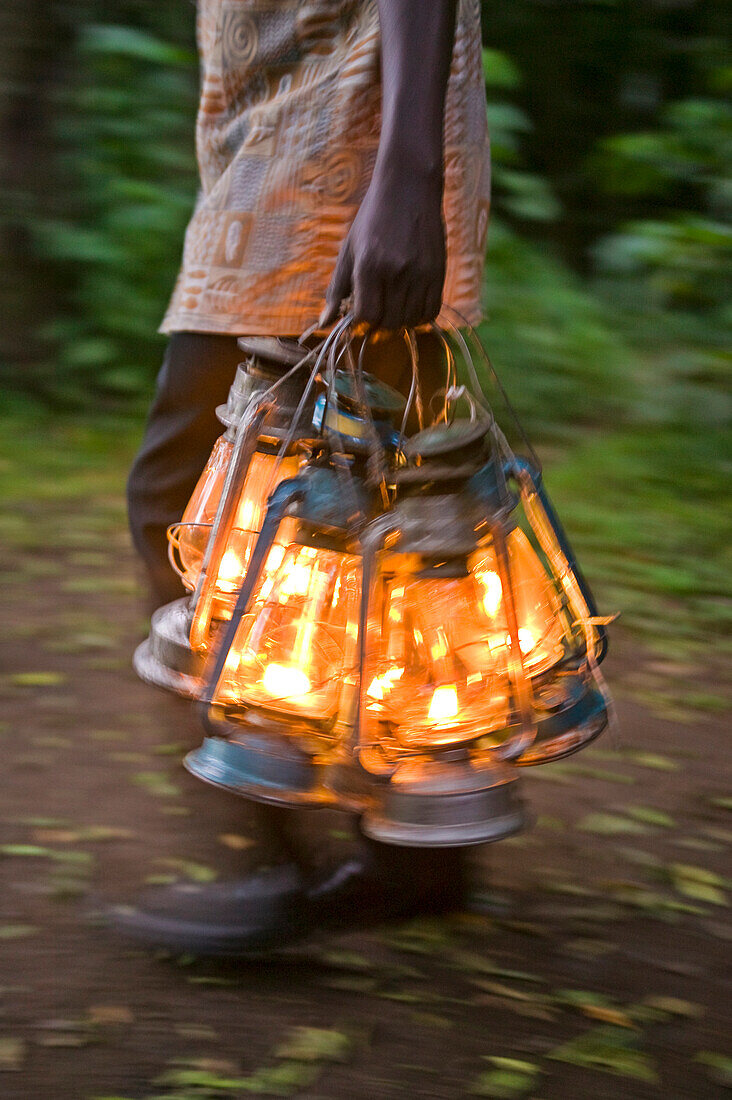 Carrying lighted kerosene lamps; Kenya