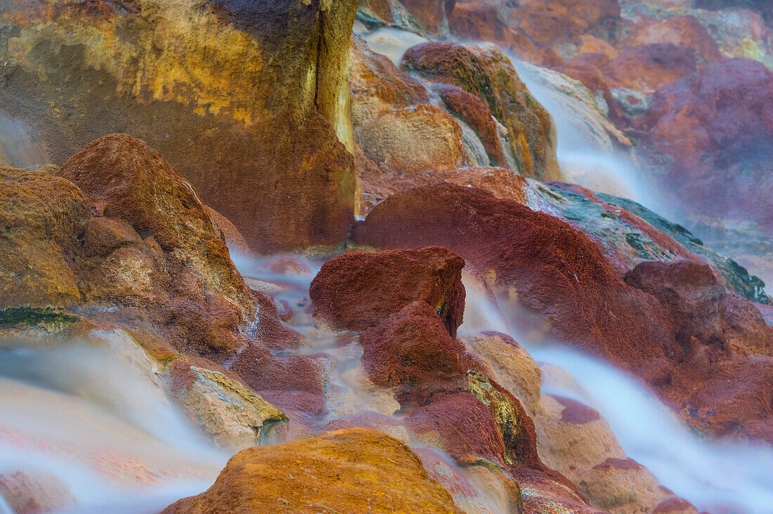 Hot water from geysers pours down rocks in the Valley of Geysers, Kronotsky Nature Reserve, Russia; Kronotsky Zapovednik, Kamchatka, Russia