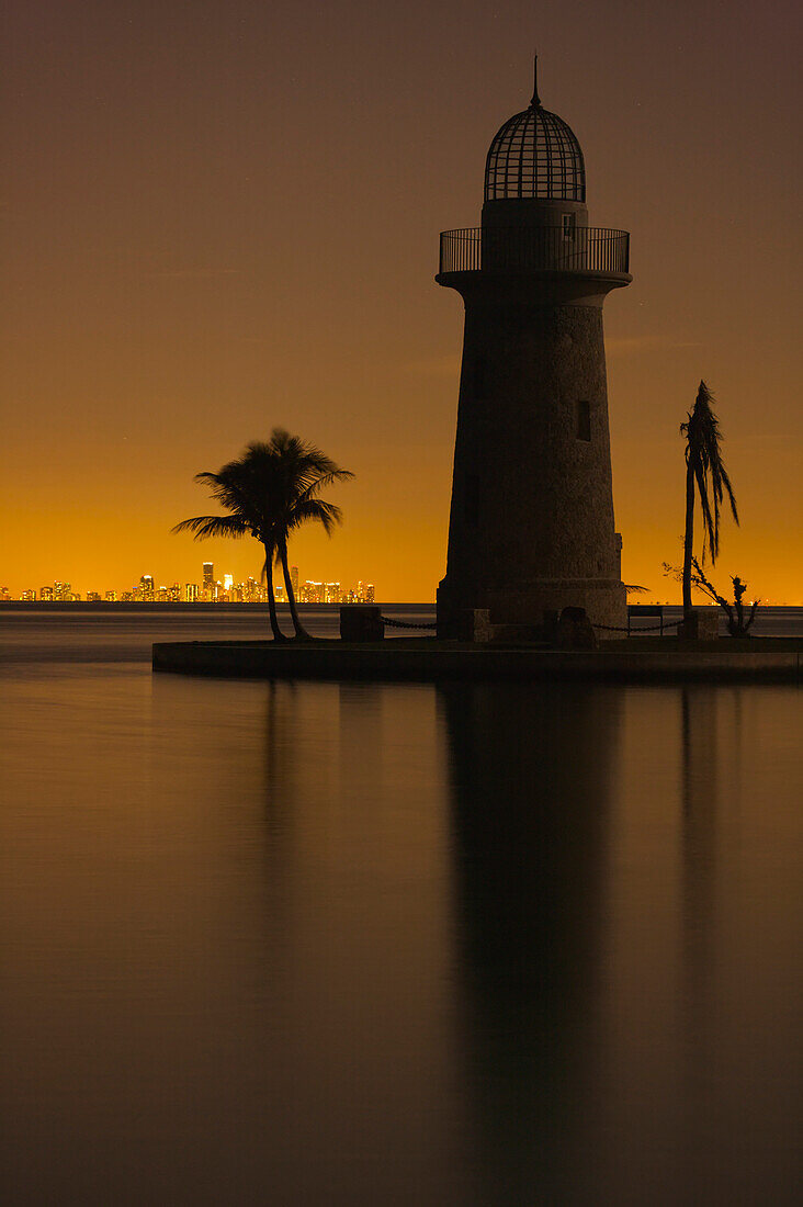 Boca Chita Lighthouse and palm trees at golden hour in Boca Chita Key, Biscayne National Park, Florida, USA; Florida, United States of America