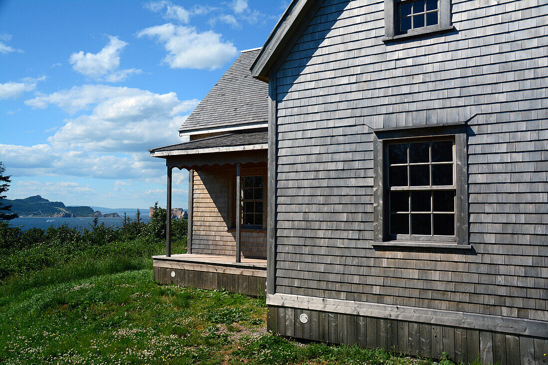 Historic homestead on Bonaventure Island with view of the Gulf of Saint Lawrence and Perce Rock.;  Ile Bonaventure et du Rocher-Perce National Park, Gaspe Peninsula, Quebec, Canada.