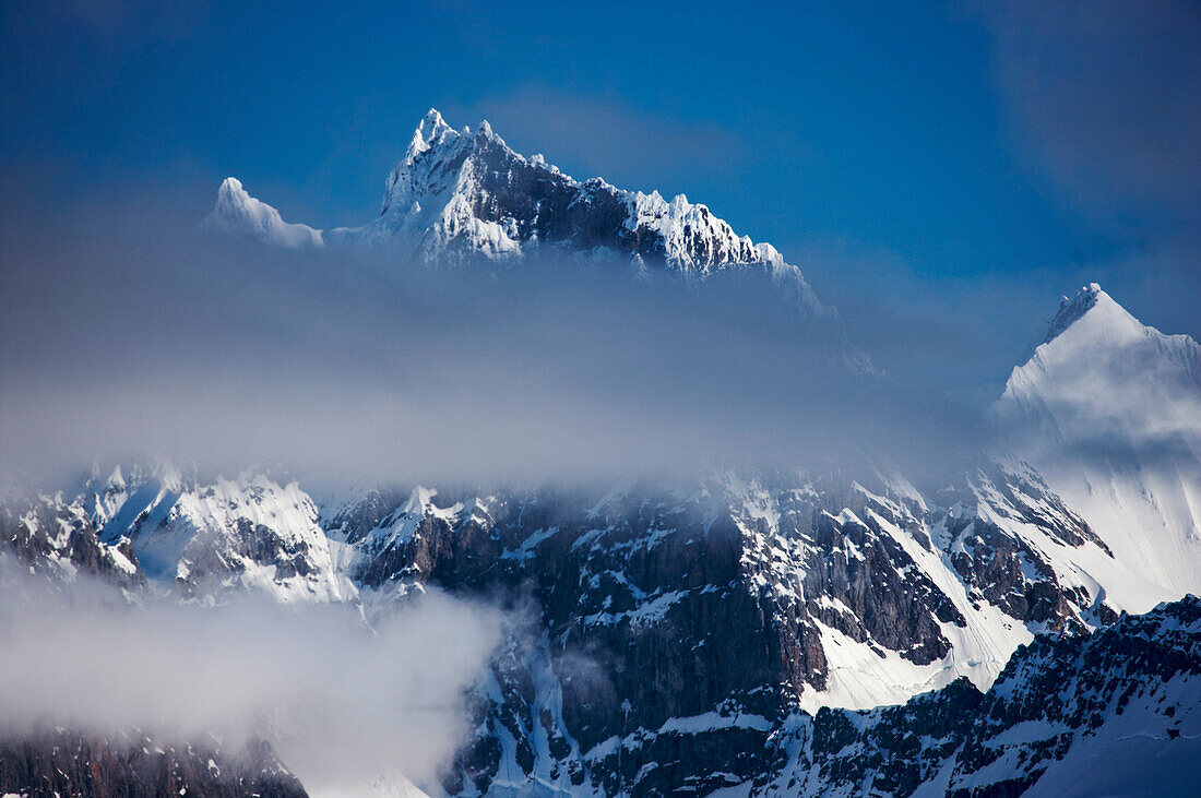 Cloud shrouded mountain peaks; Krossfjord, West Spitsbergen, Svalbard Archipelago, Norway.