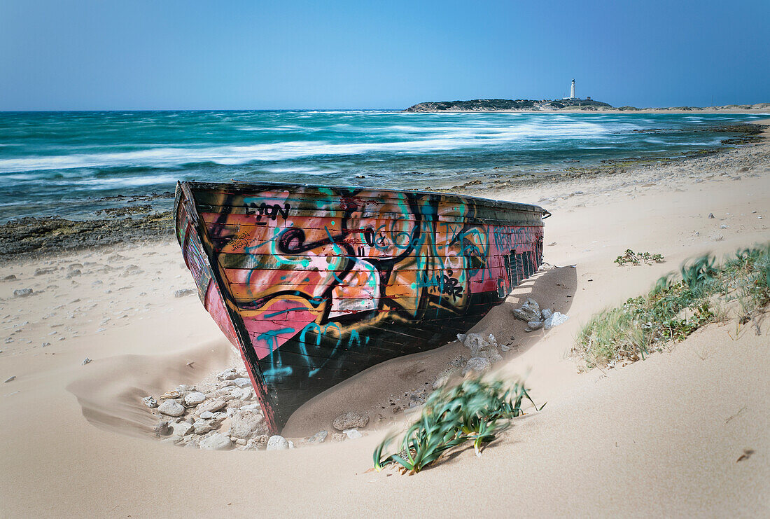 A Colourfully Painted Rowboat On Canos De Meca Beach; Cape Trafalgar Cadiz Andalusia Spain