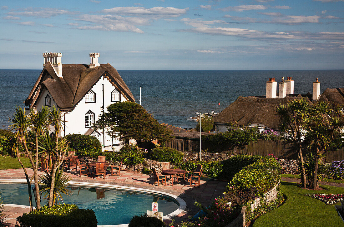 Thatched Cottages And A Swimming Pool Along The Ocean; Sidmouth Devon England