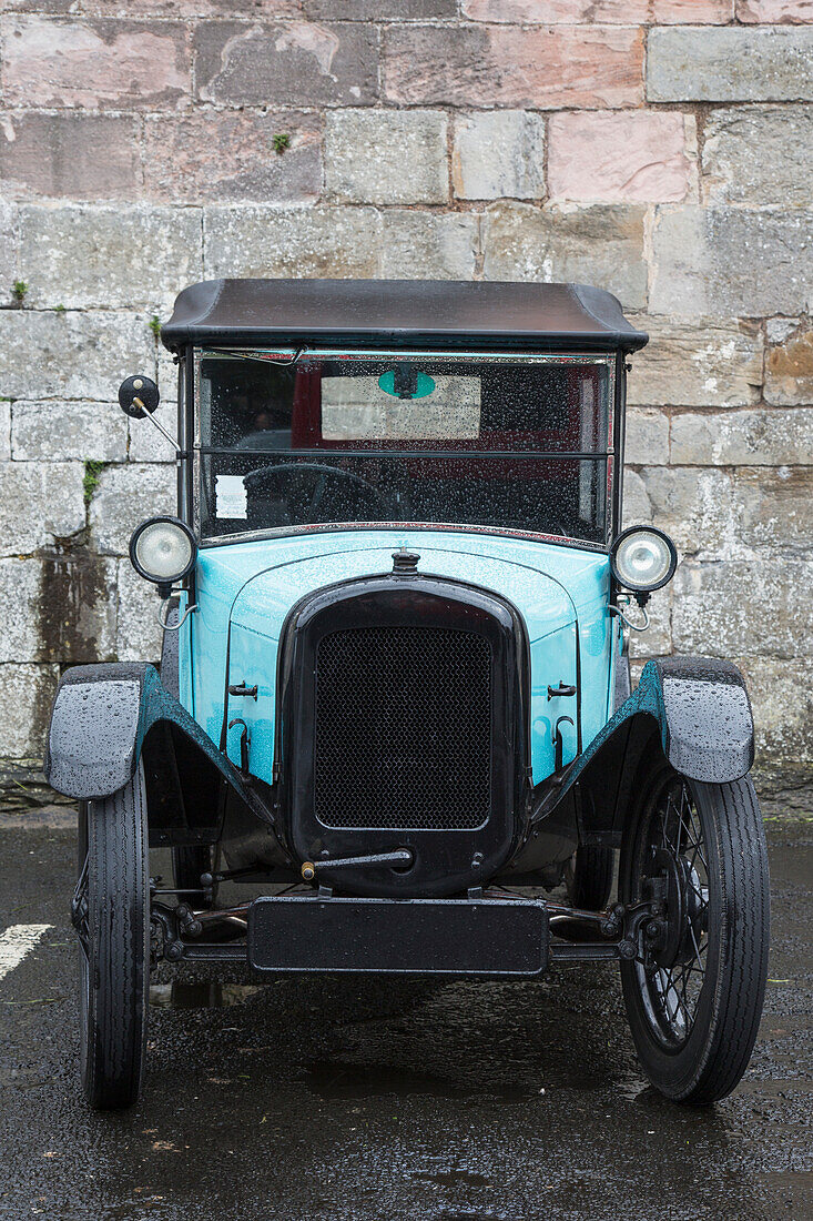 A Vintage Car Parked Along A Stone Wall; Berwick Northumberland England