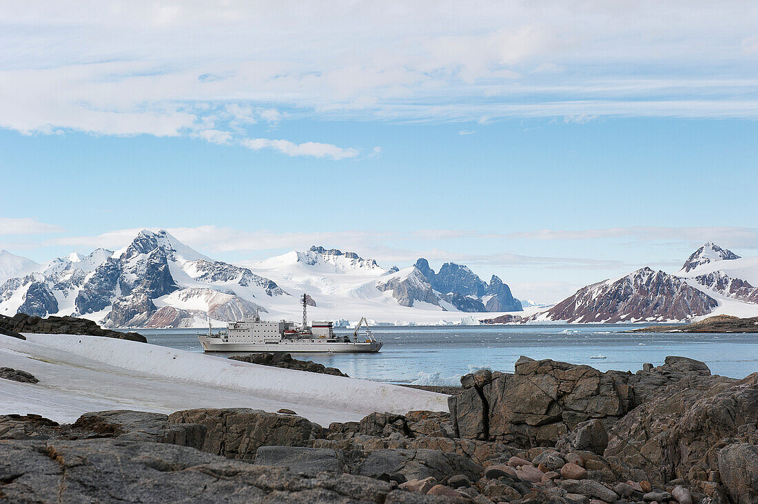 A Ship Travels Along The Coastline; Antarctica