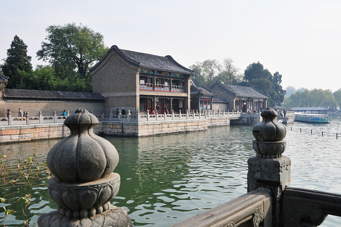 Pedestrians On A Promenade Along A River; Beijing China