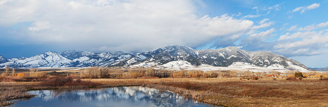 Panarama Of Mountains Reflected In A Lake; Bozeman Montana United States Of America