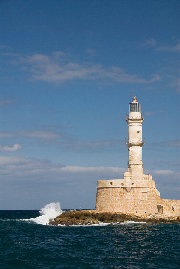 Greece, Crete, Hania, Wave crashing on a lighthouse.