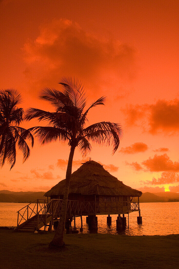 Panama, San Blas Islands (also called Kuna Yala Islands), Yandup Island, sunrise over the water hut.