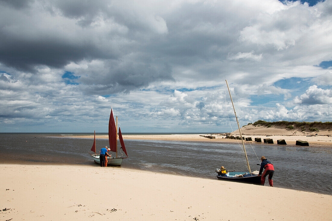 Preparing Sailboats At The Water's Edge; Alnmouth Northumberland England