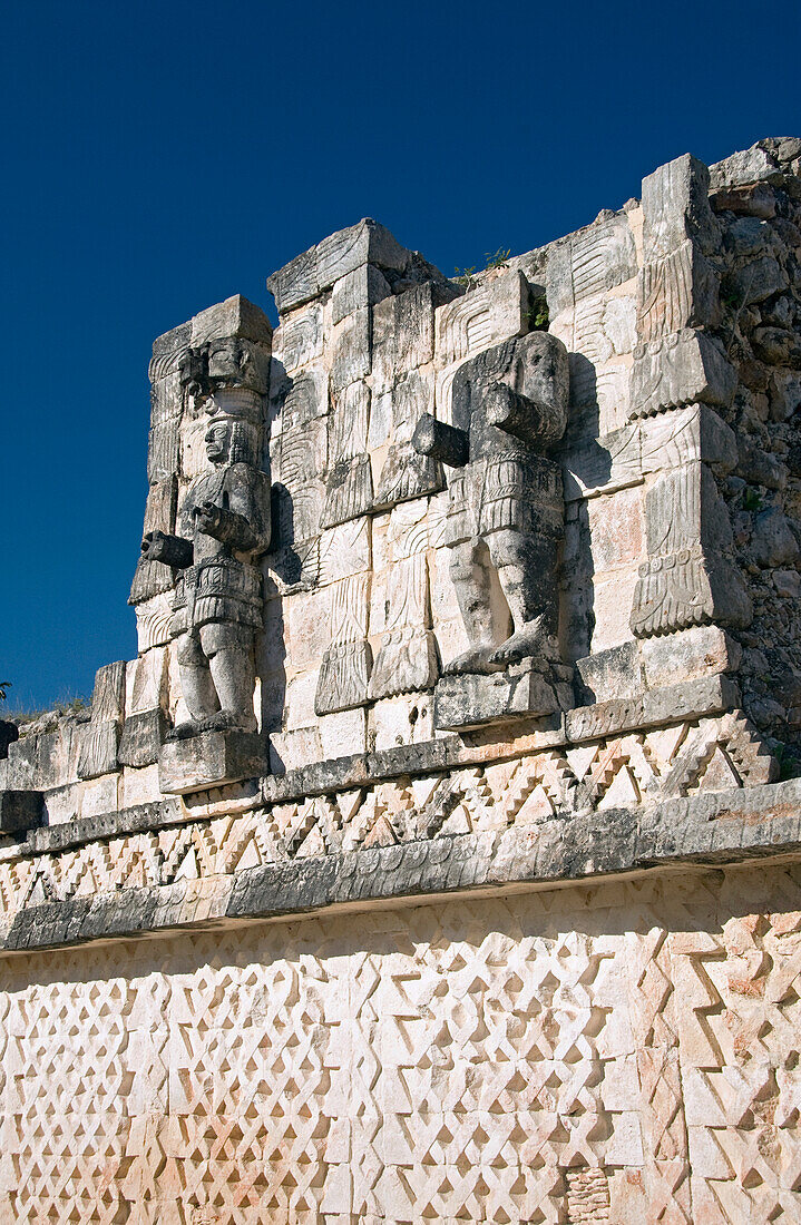 Mexico, Yucatan, Kabah, back side of the Palace of Masks, the unusual restore Atlantes (stone carved male figures)